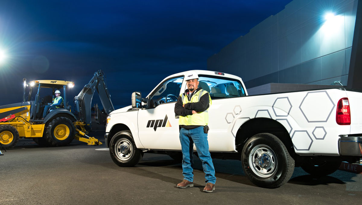NPL worker standing in front of a white work truck