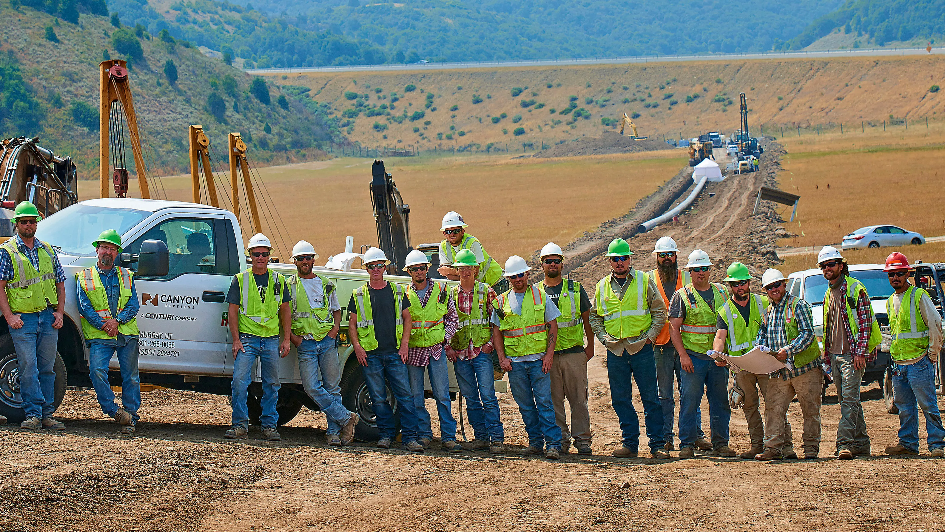 Workers posing for a picture at a work site